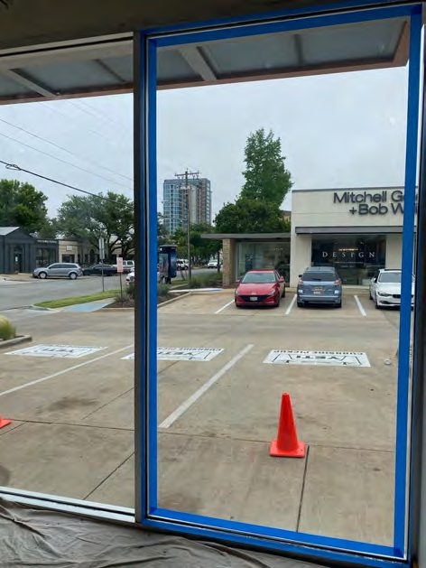 Correct security film installation by Epic: Storefront entry, every side anchored.